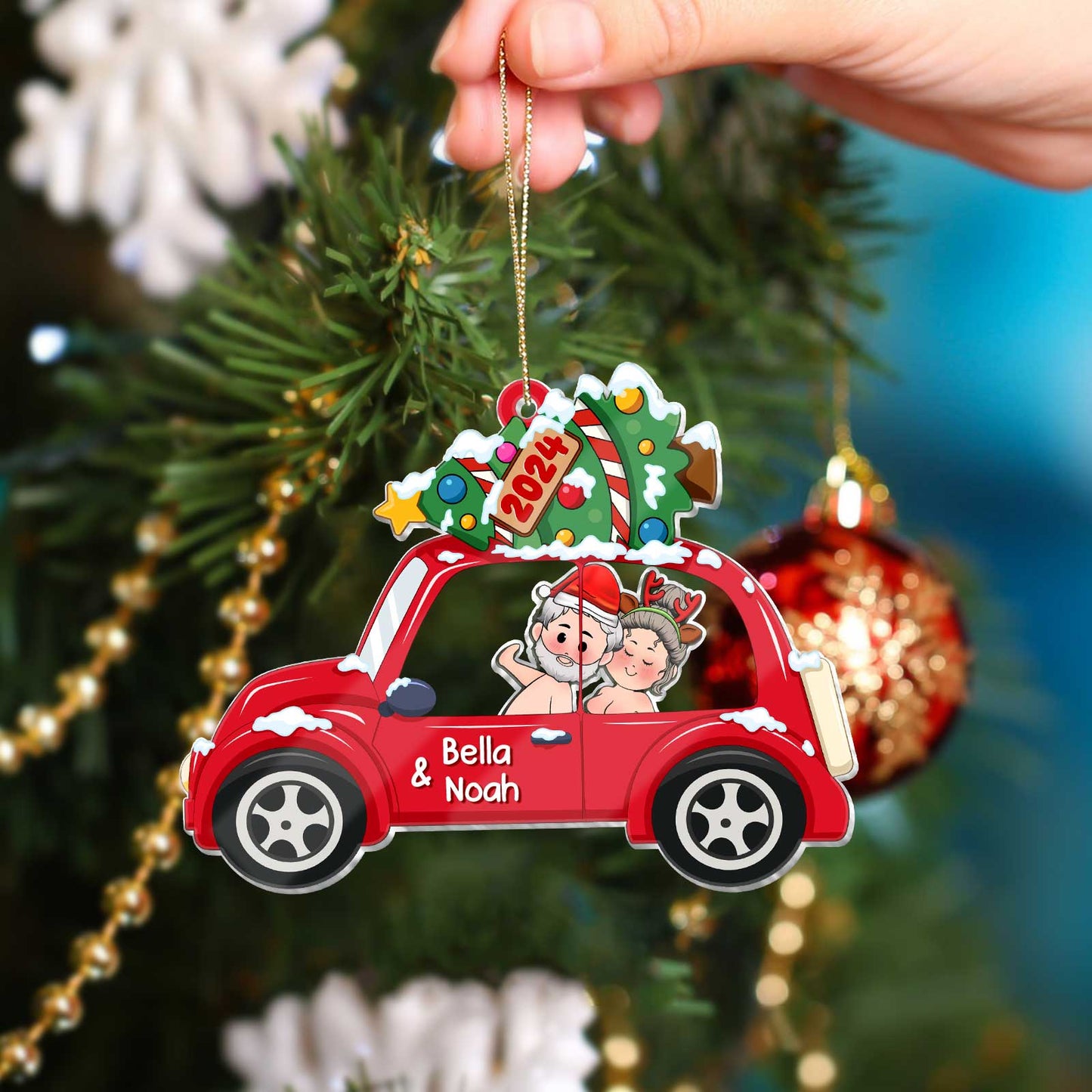 Red car personalized couple Christmas ornament with names Bella and Noah hanging on Christmas tree
