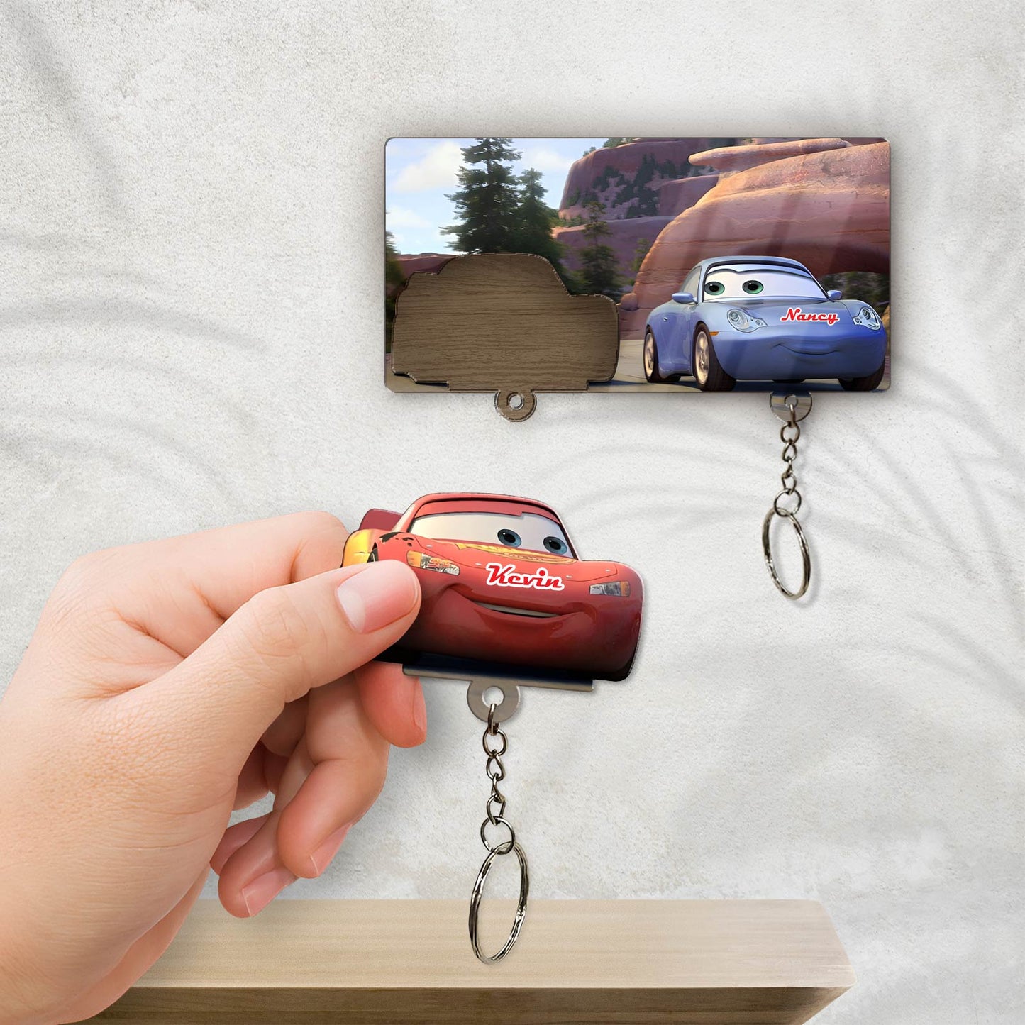 Personalized couple key holder featuring red and blue cartoon car designs with custom names