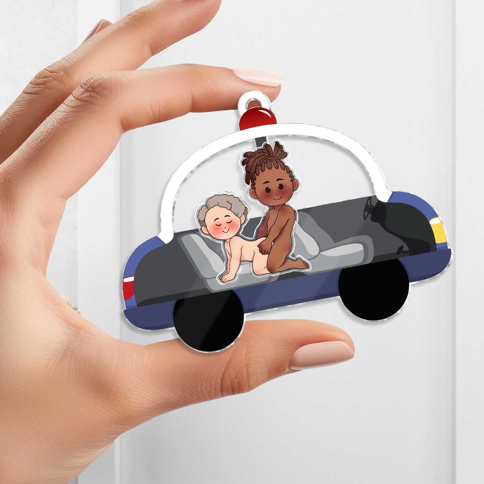 Personalized couple keychain depicting two cartoon characters in a colorful car for a special gift