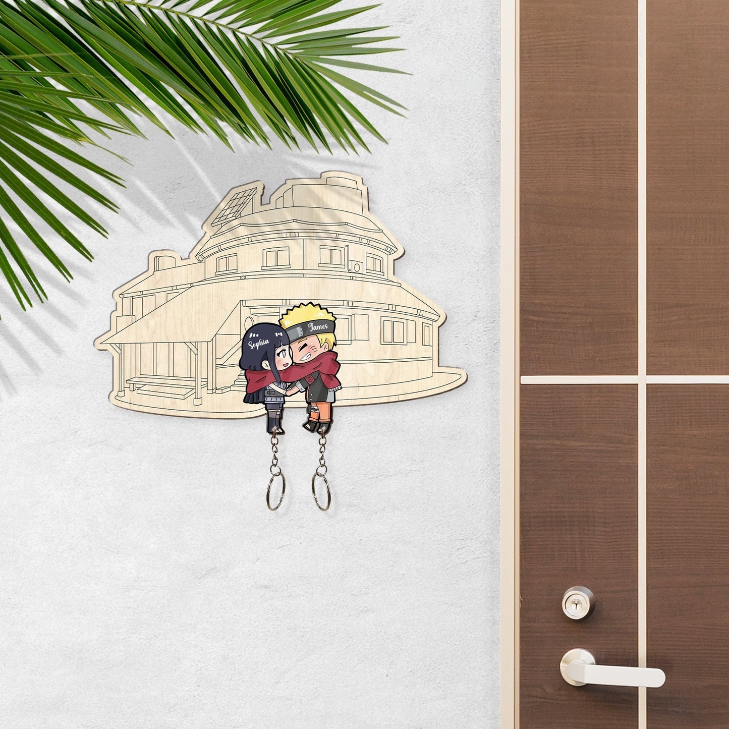 Personalized couple keychain featuring cartoon characters hanging on a wall near a wooden door