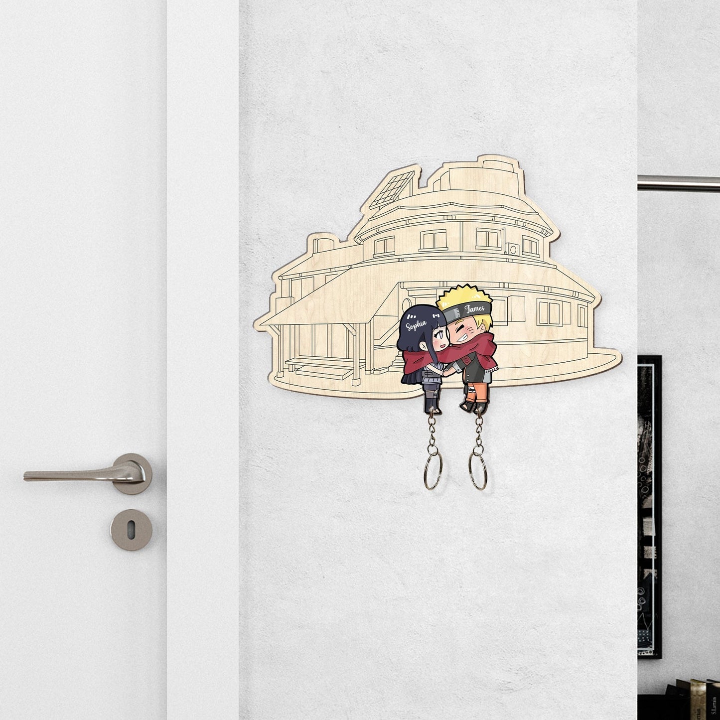 Personalized couple keychain featuring cartoon couple hugging in front of a house outline wall hook