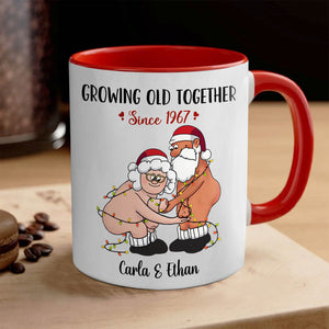 Personalized couple mug with cartoon elderly Santa and Mrs Claus wrapped in lights and custom names Carla and Ethan