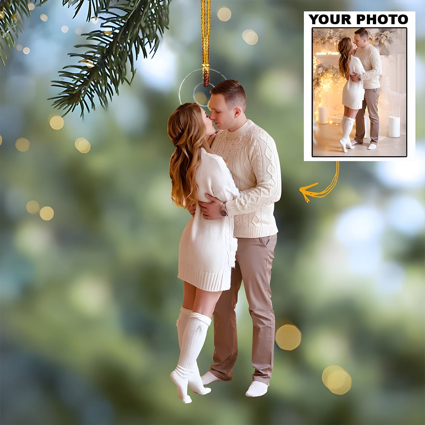 Personalized couple photo ornament hanging on Christmas tree branch with a cozy couple in winter attire