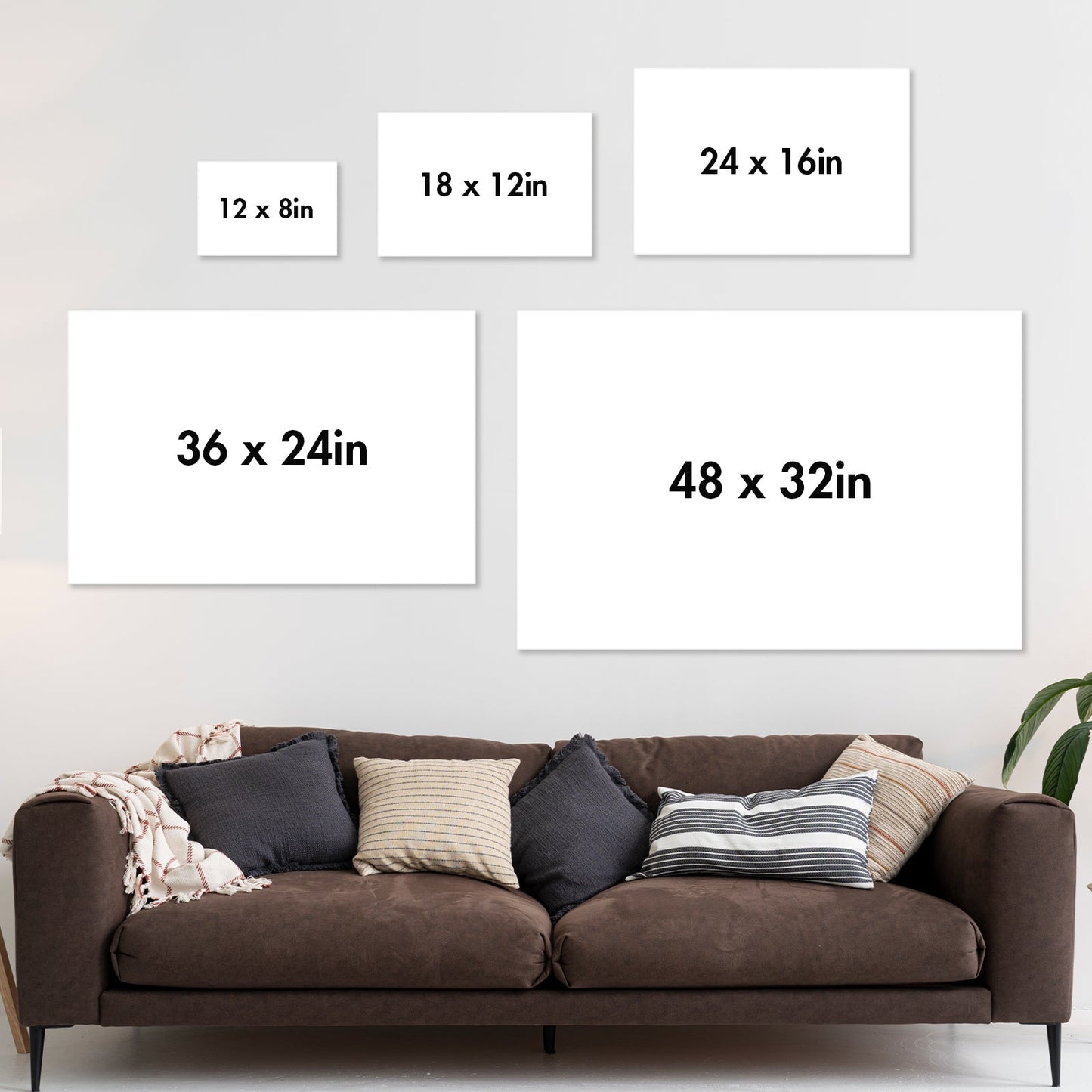Living room with brown sofa and five blank white posters showing sizes for personalized couple poster options