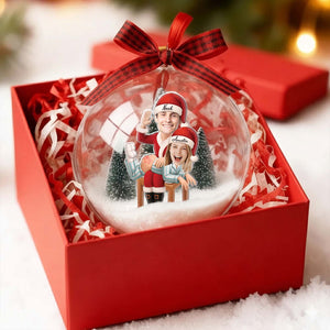 Personalized couple snow globe ornament in a festive gift box with holiday decorations