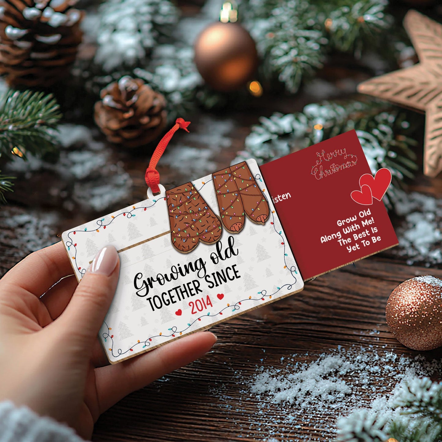Personalized couples Christmas ornament with mitten design and custom year hanging on red ribbon