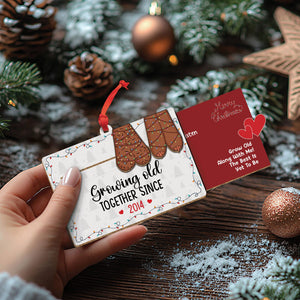 Personalized couples Christmas ornament with mitten design and custom year hanging on red ribbon