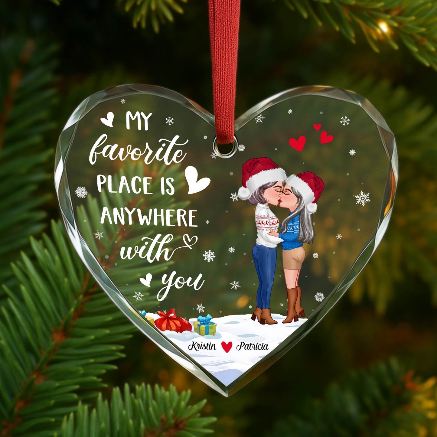 Personalized couples glass ornament featuring a kiss under winter snow with festive hats and hearts