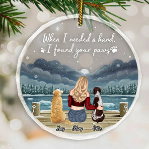 Personalized dog lover ornament featuring a woman with two dogs by a snowy lake