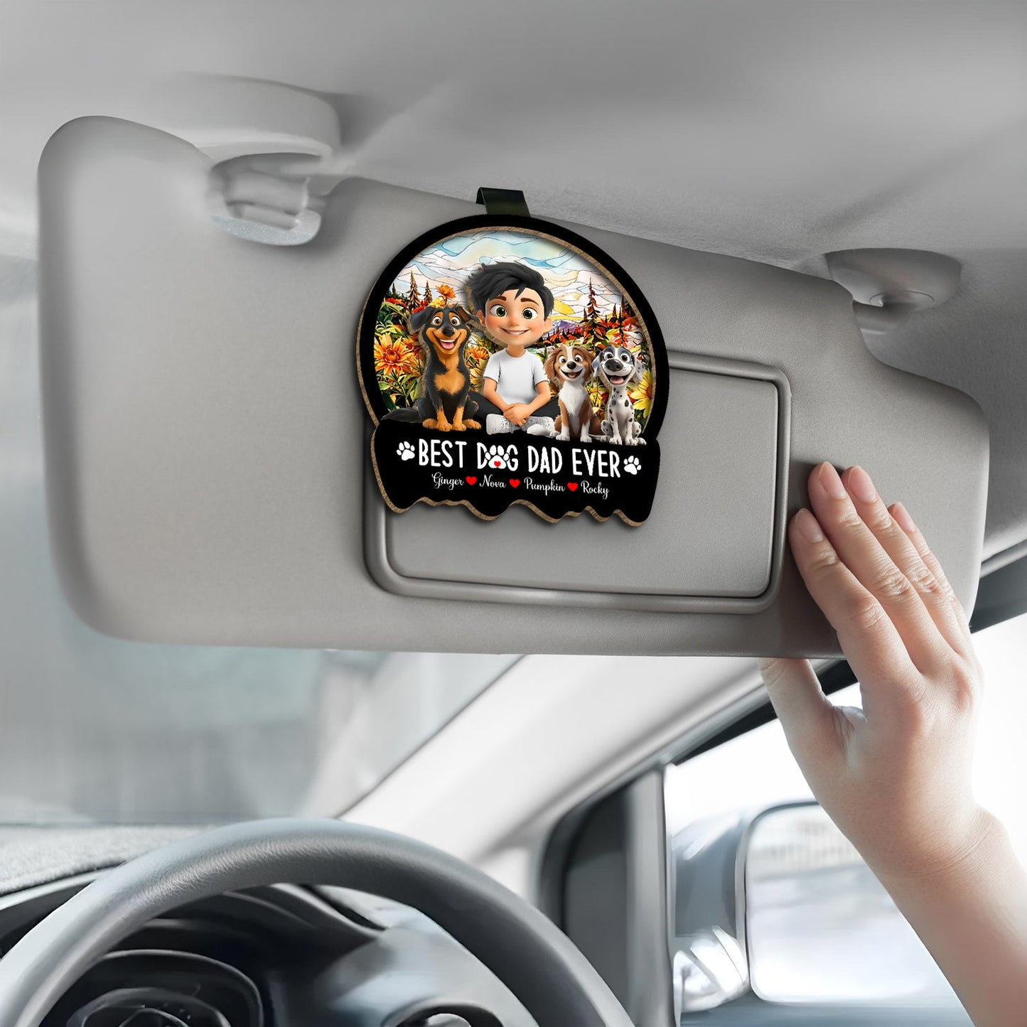 Personalized dog mom car visor clip featuring two dogs and a child in a scenic background
