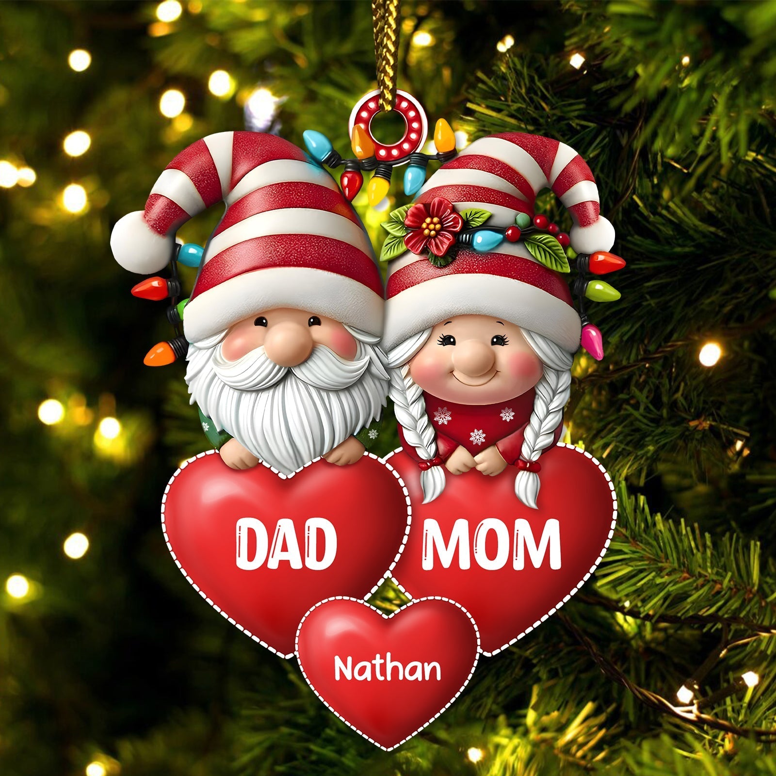 Personalized family Christmas ornament featuring Santa and Mrs. Claus with red hearts and custom name