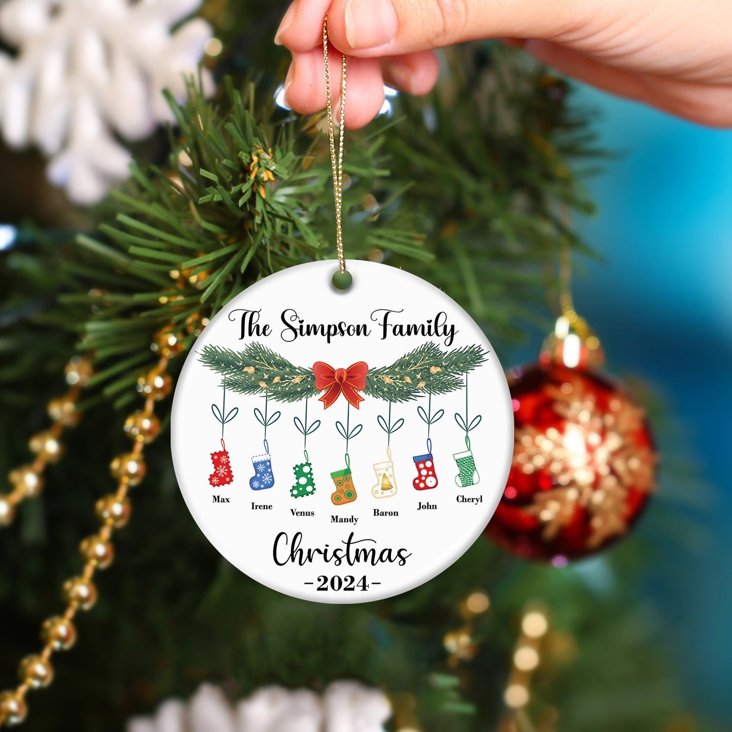 Personalized family Christmas ornament with names and stockings hanging on pine branch 2024