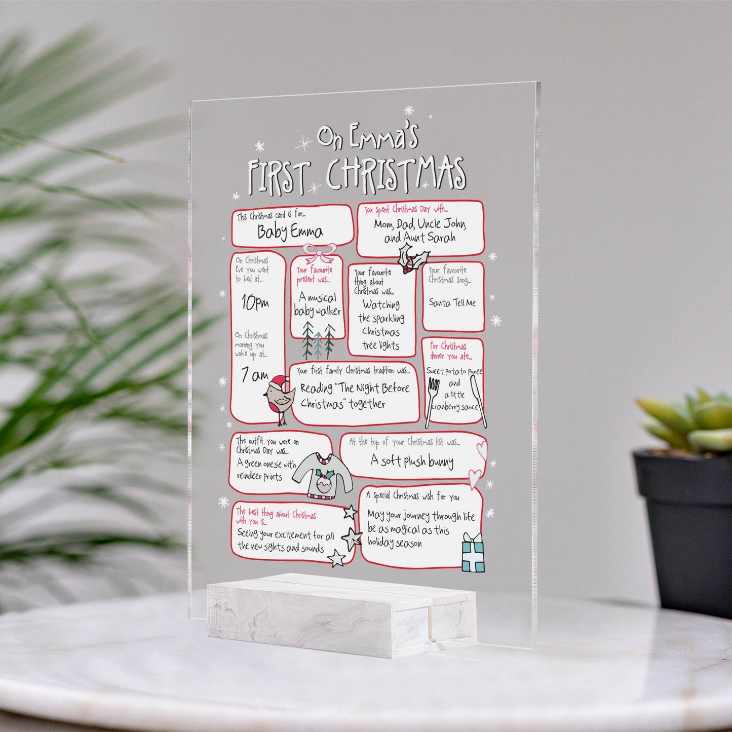 Personalized family Christmas plaque with custom text for Emma's first Christmas displayed on marble table