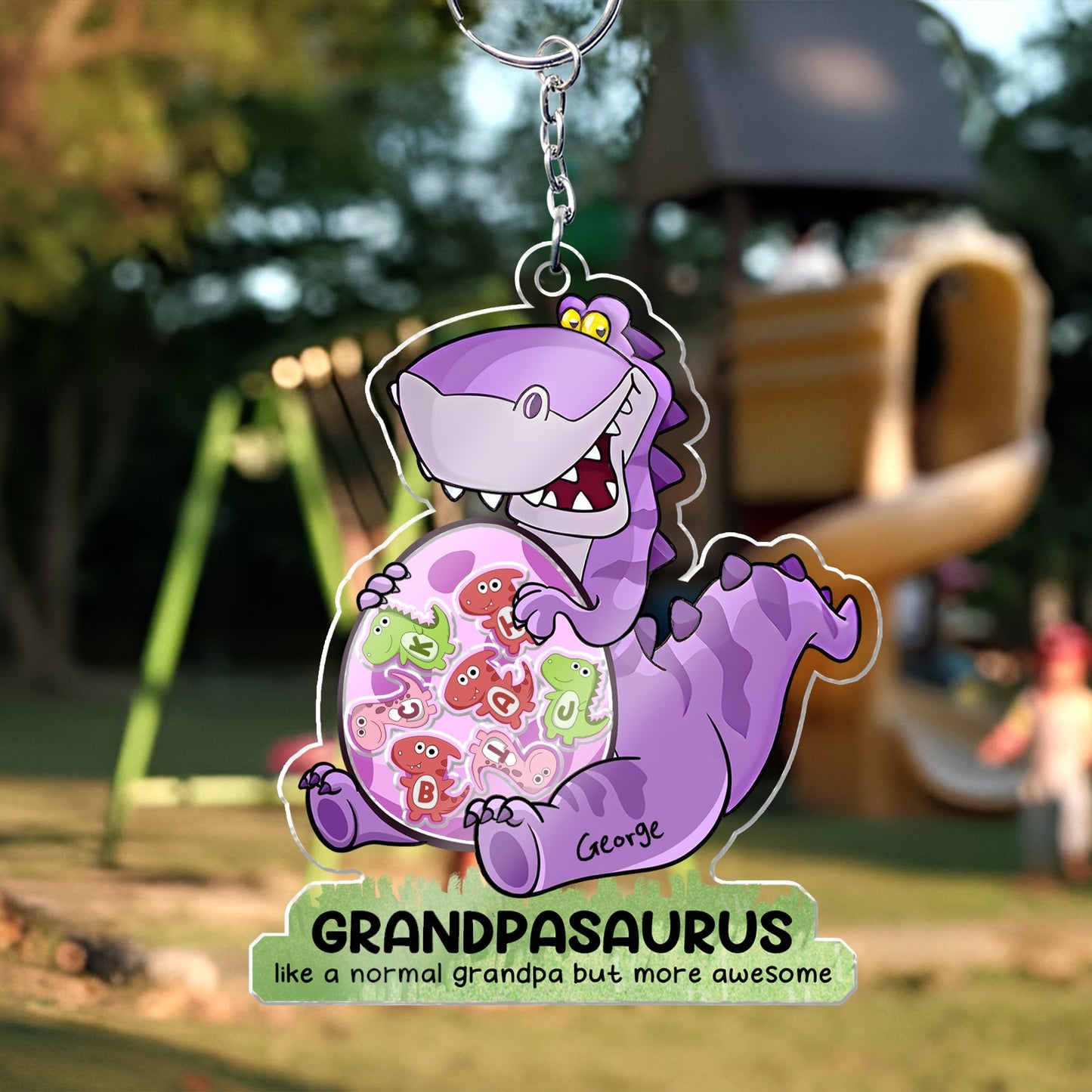 Personalized grandpa keychain featuring a cartoon dinosaur with colorful designs and the name George
