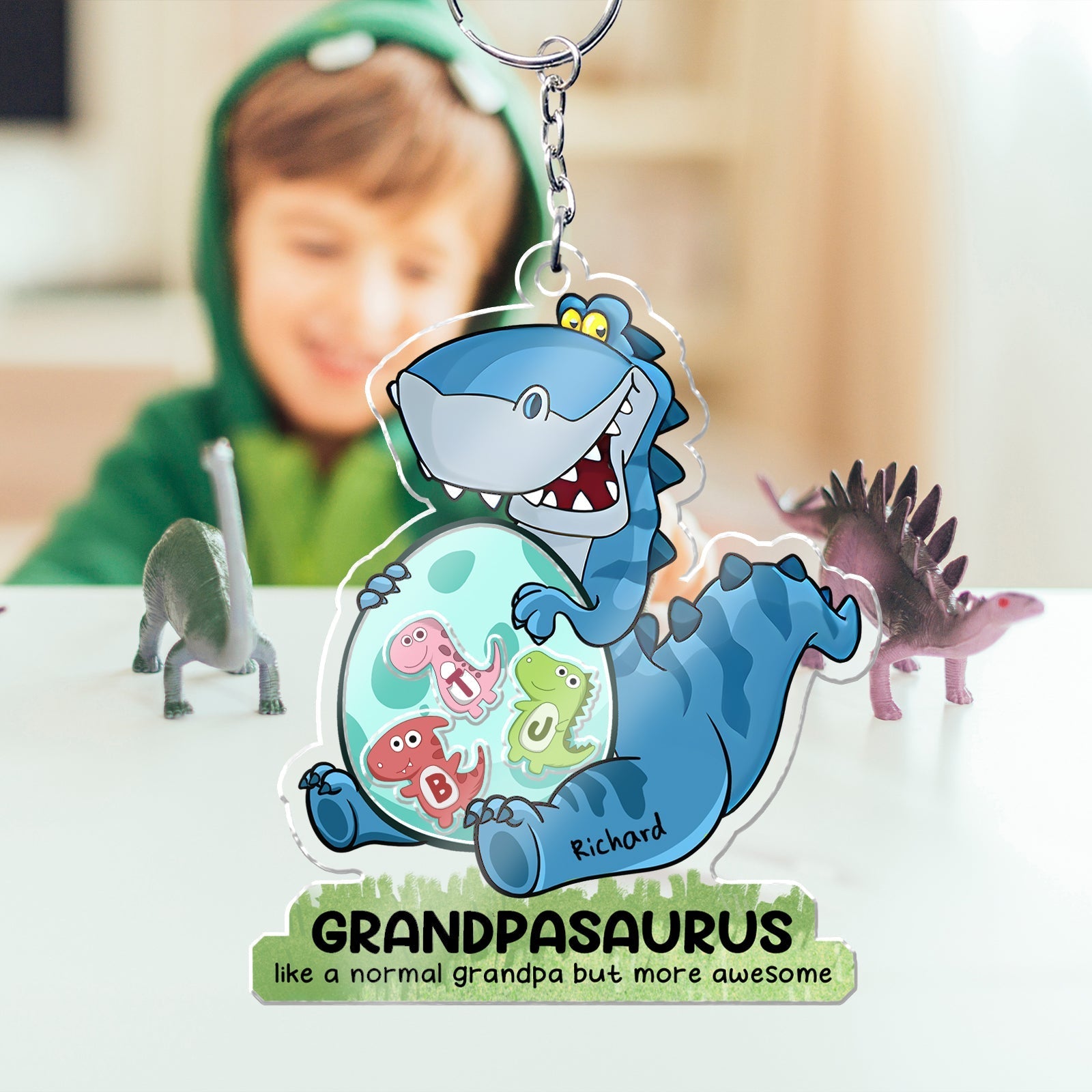 Personalized grandpa keychain with a cartoon dinosaur design that says Grandpasaurus
