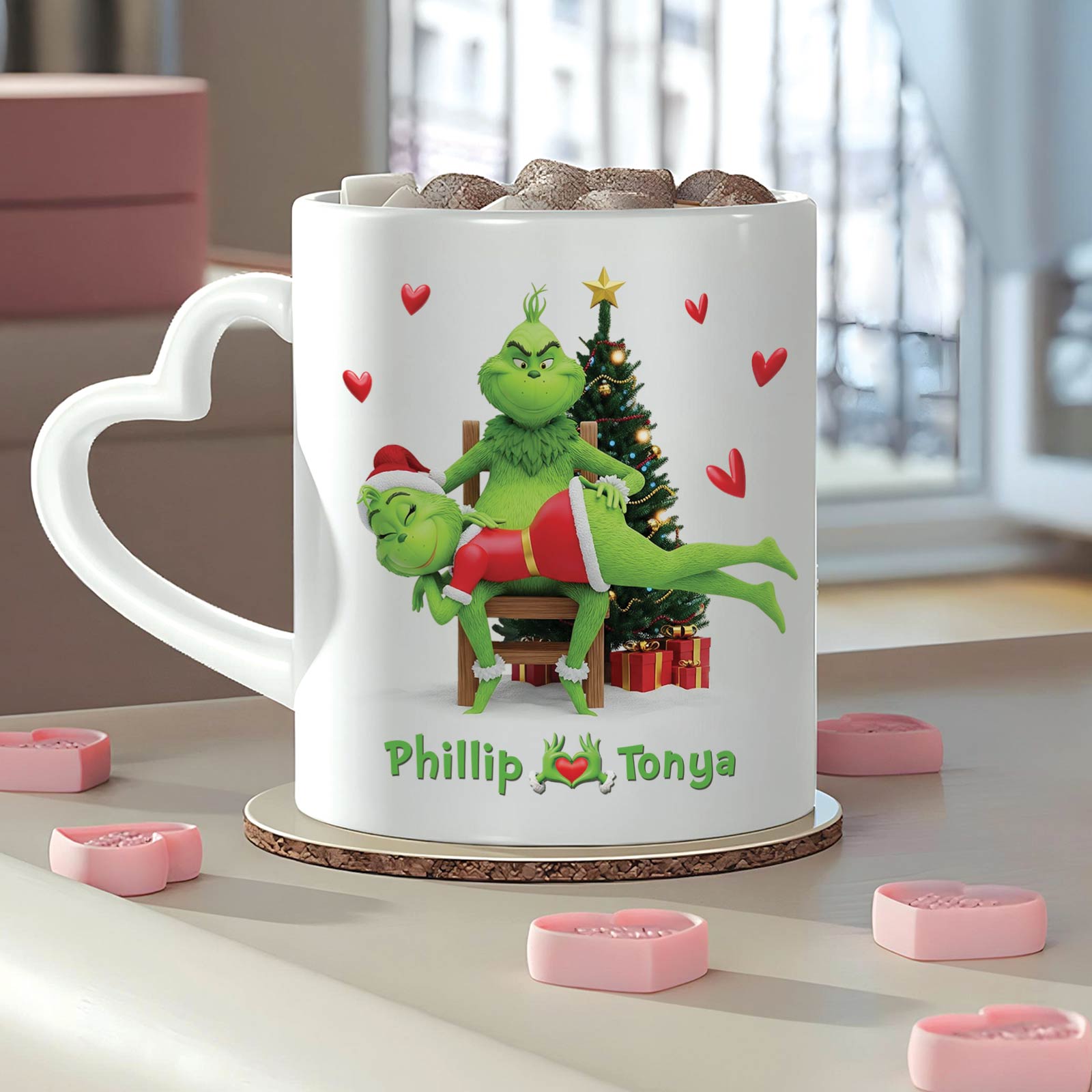 Personalized Grinch Christmas mug featuring festive design with names Phillip and Tonya in a cozy setting