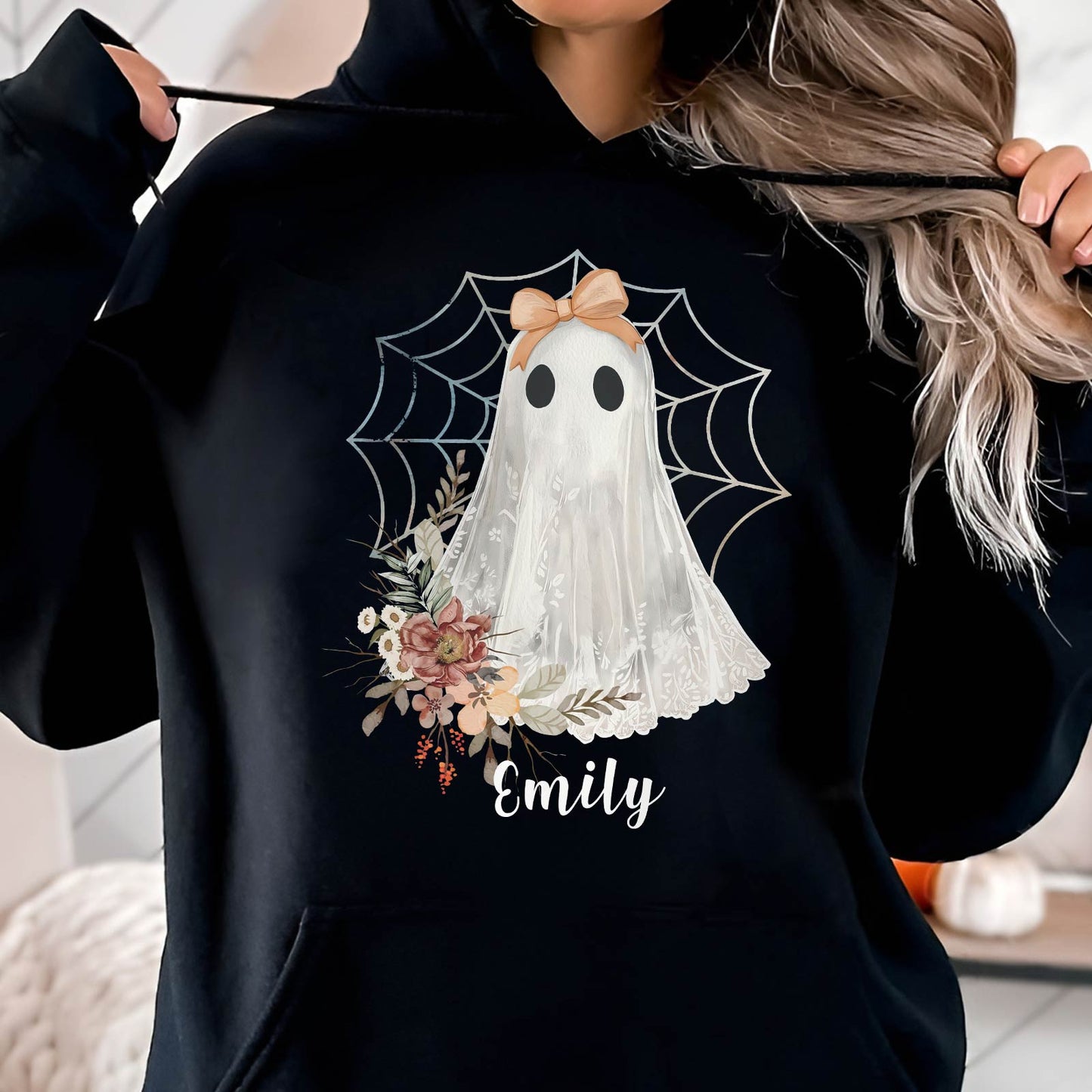Black hoodie featuring a personalized Halloween ghost shirt with floral design and spider web background