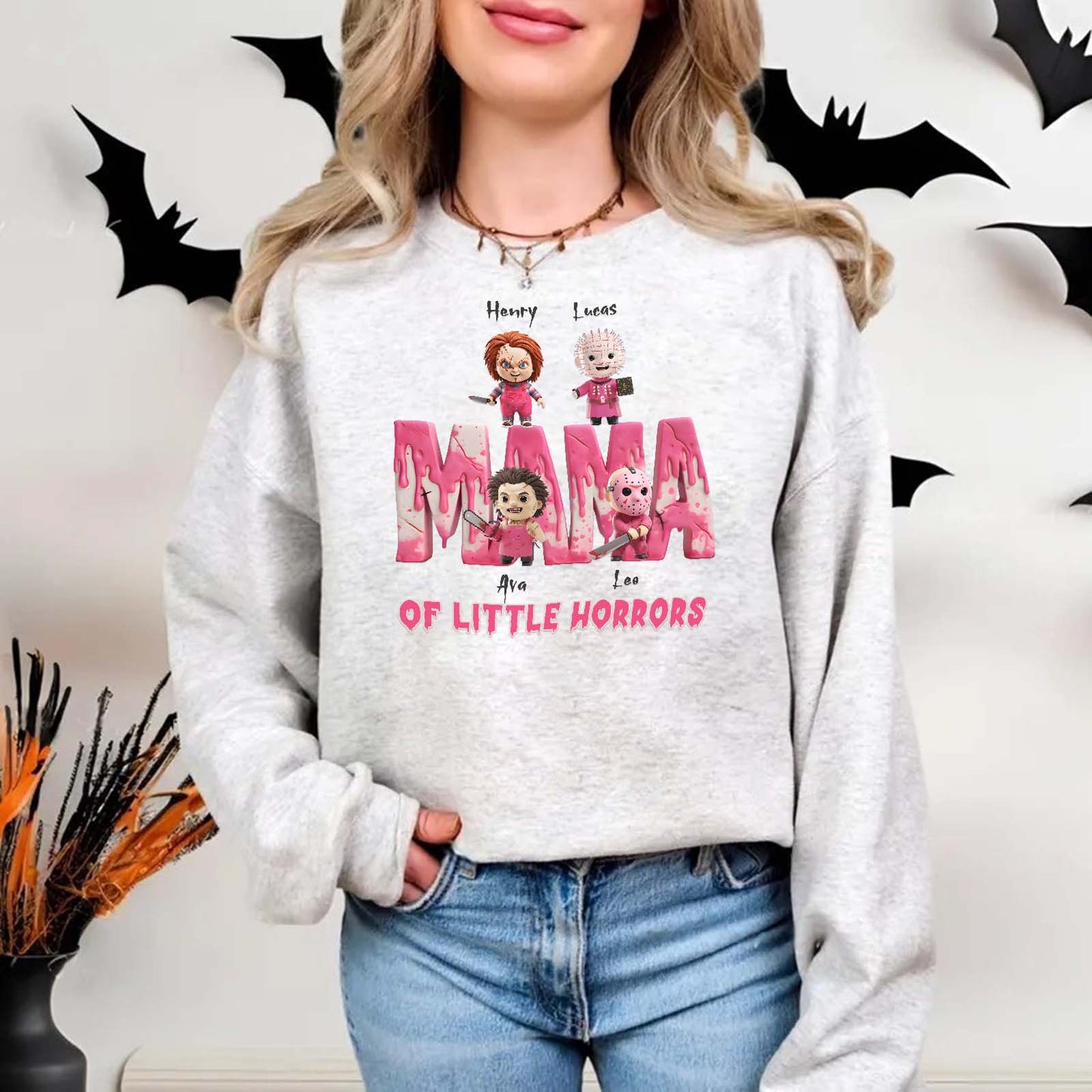 Woman wearing a personalized Halloween mama shirt with cute horror character designs in pink