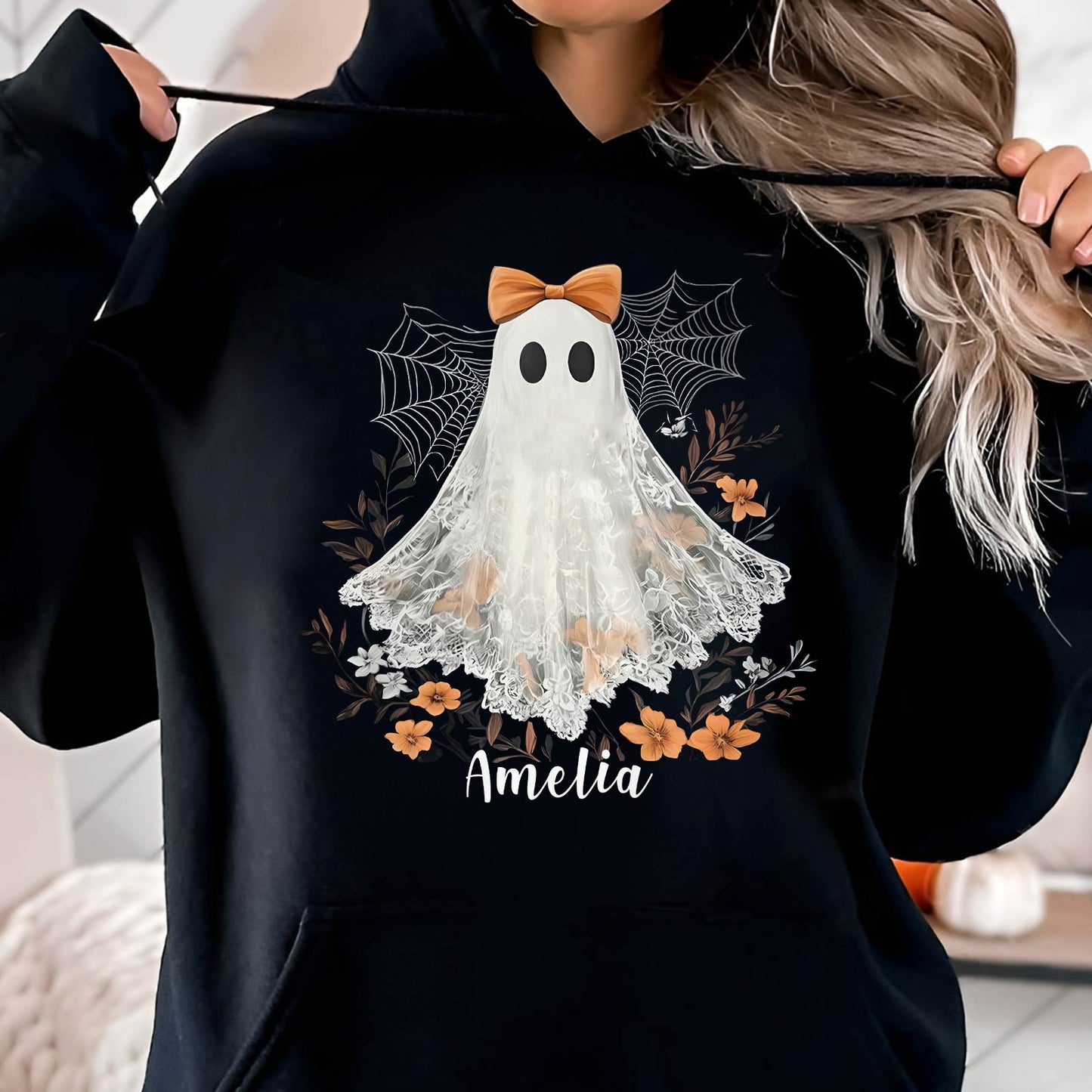 Black personalized Halloween shirt with ghost wearing bow and floral design with custom name Amelia
