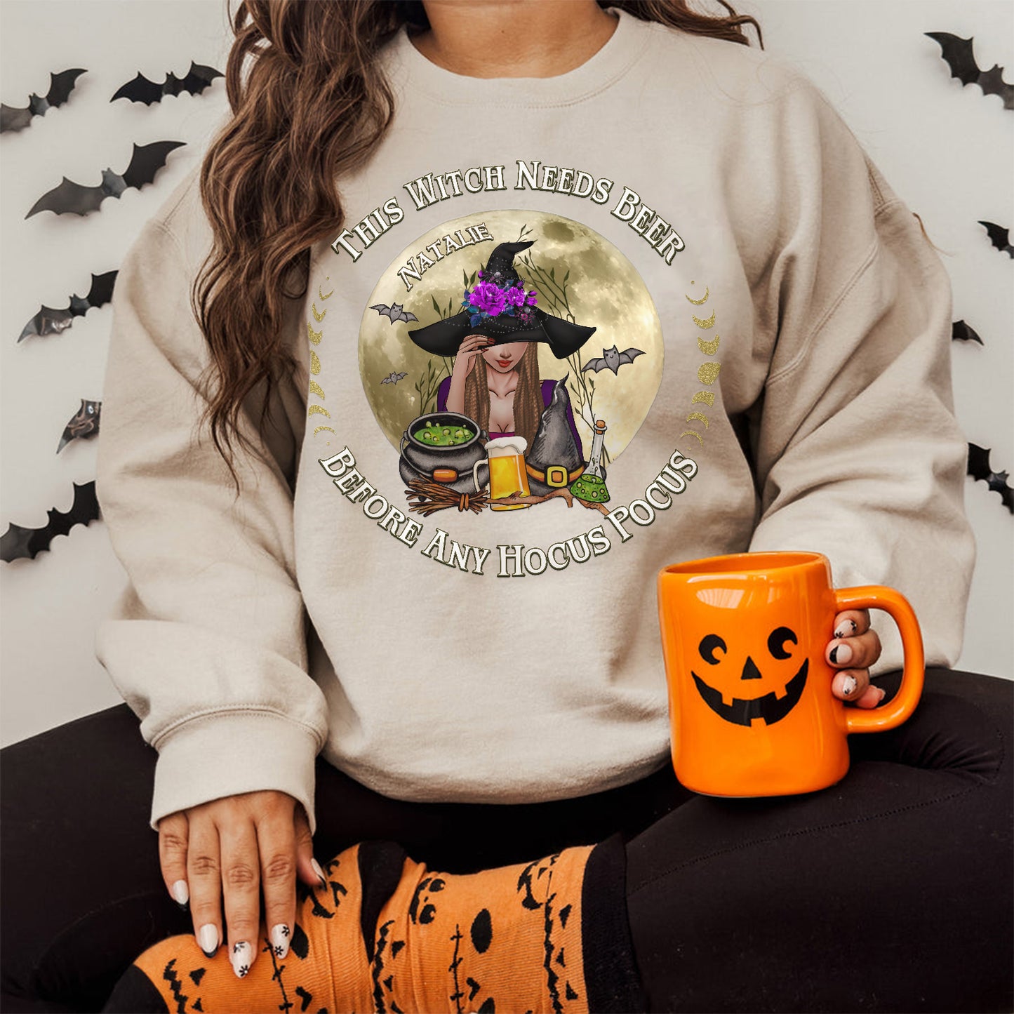365Gifty personalized Halloween sweatshirt with witch design holding beer and Halloween-themed decorations