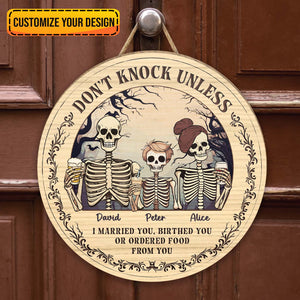 Personalized Halloween wooden door sign featuring skeletons and customizable names for spooky decor
