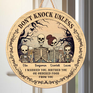 Personalized Halloween wooden door sign featuring skeletons and spooky text for festive decor