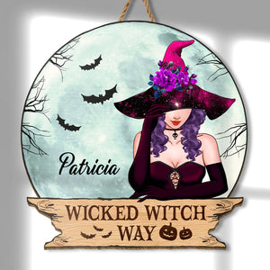 Personalized Halloween wooden door sign featuring a witch with bats and floral accents