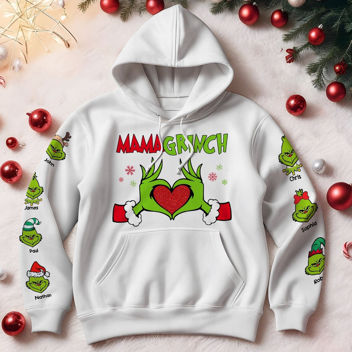 White personalized Mimi Grinch Christmas shirt hoodie with Mama Grinch design and custom names on sleeves