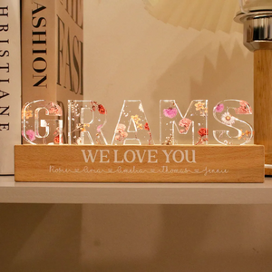 Personalized mom birth LED light with a wooden base and colorful floral design spelling Grams