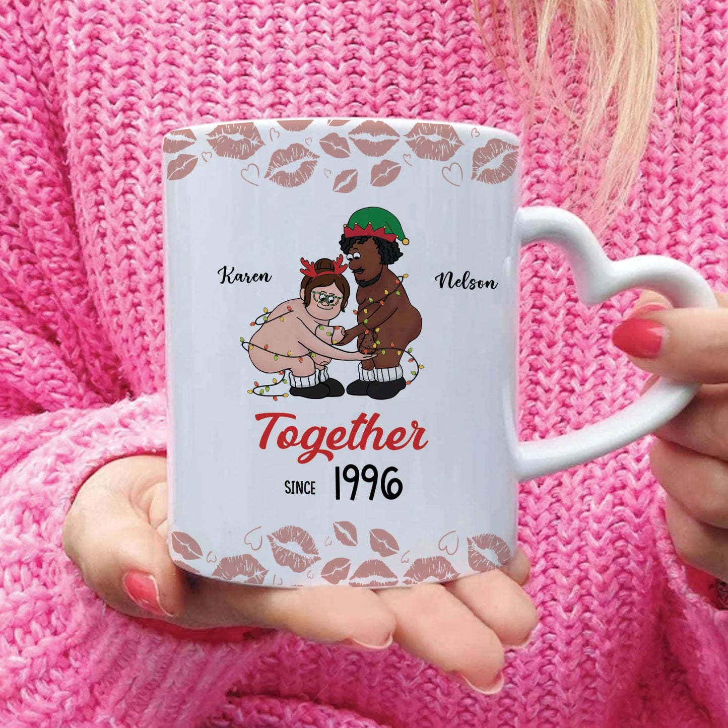 Personalized old couple mug with cartoon design and heart-shaped handle held by person in pink sweater