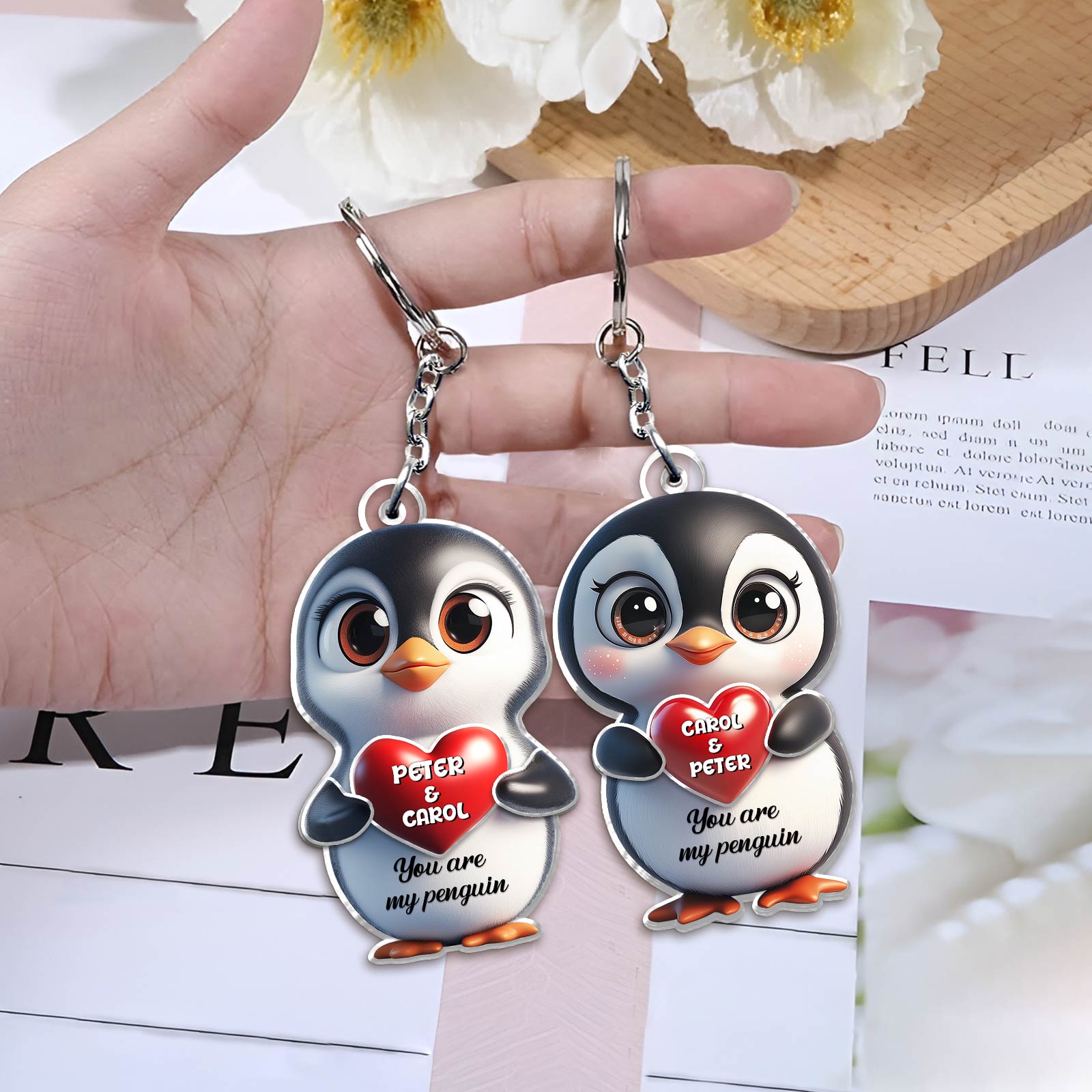 Personalized penguin couple keychain featuring cartoon penguins with custom names and heart design