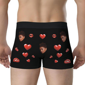 Personalized photo boxer shorts with vibrant heart and face designs on a black background.