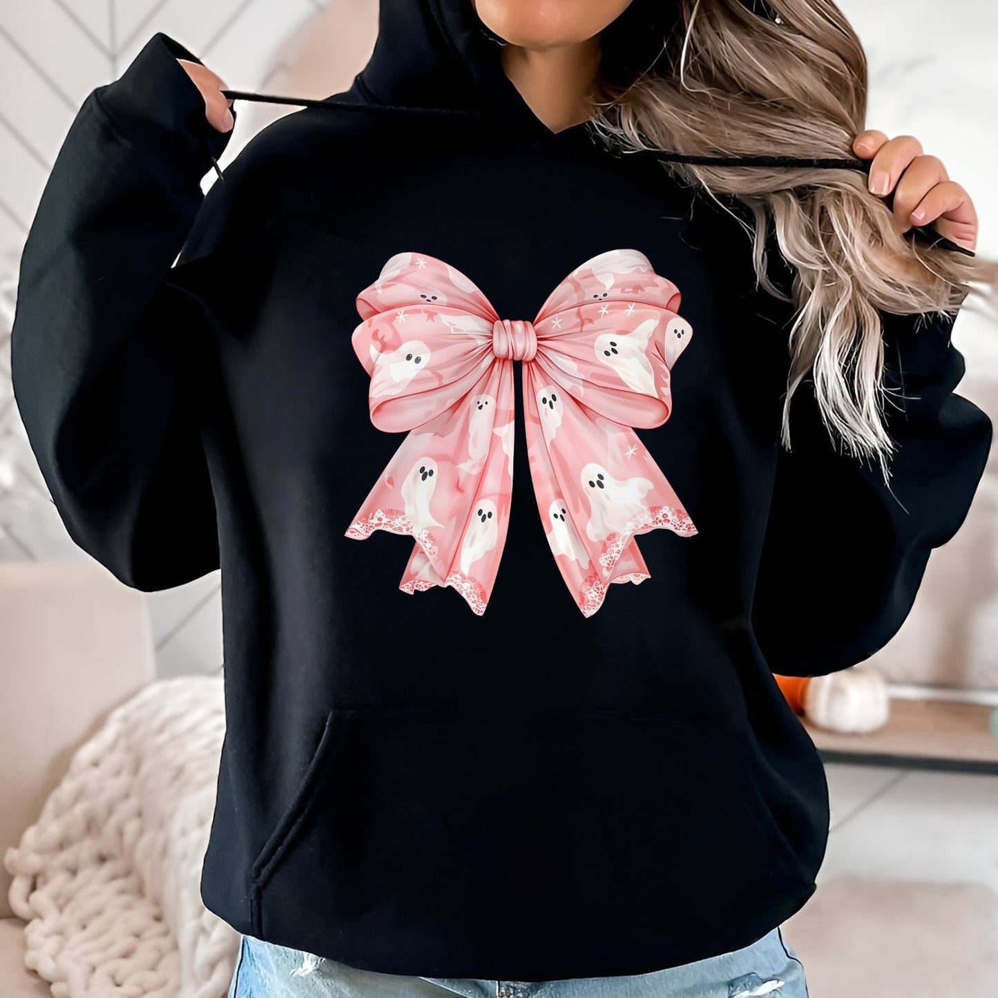 Black hoodie featuring a large personalized pink Halloween shirt bow with ghost patterns