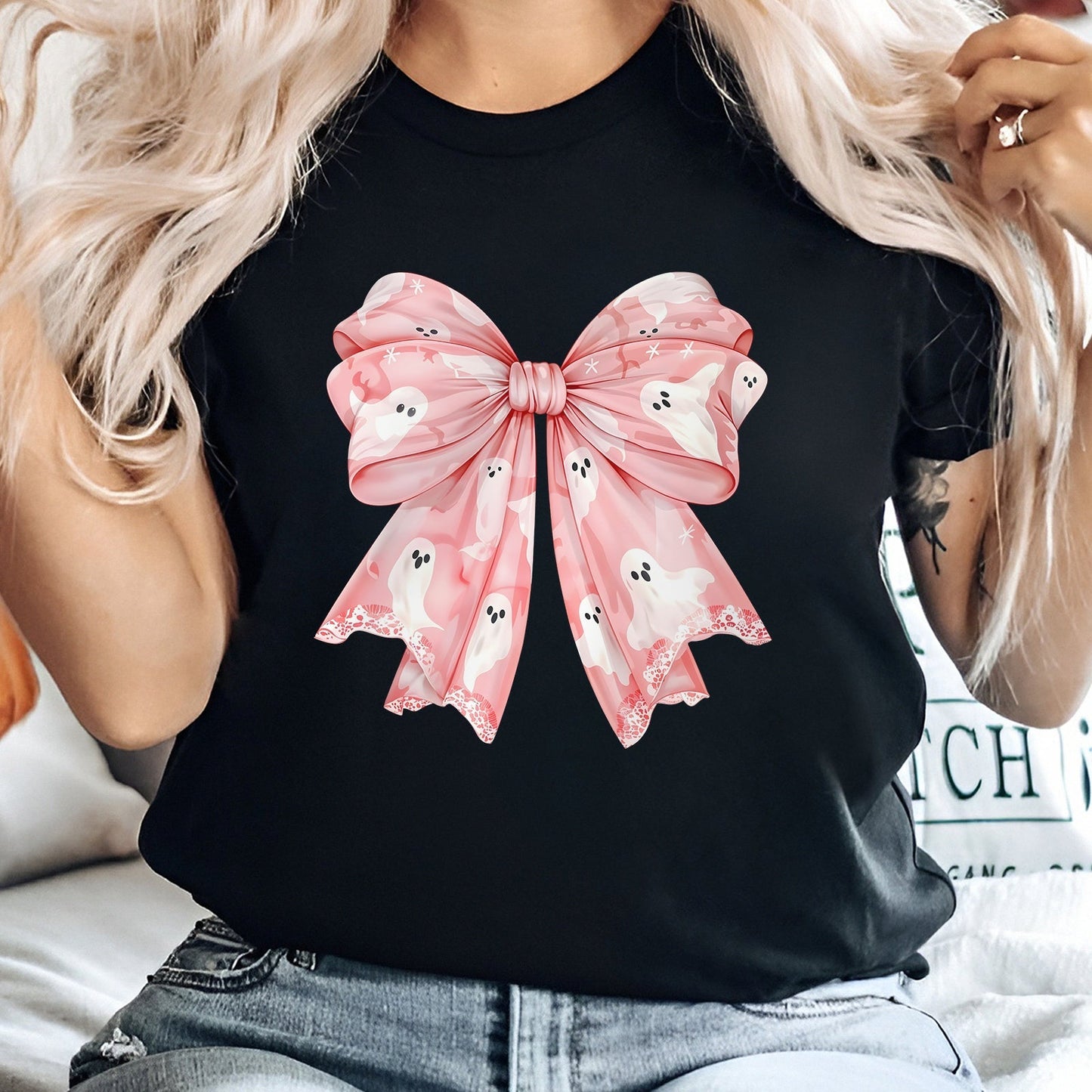 Black shirt with a large pink bow featuring white ghosts perfect as a personalized pink Halloween shirt