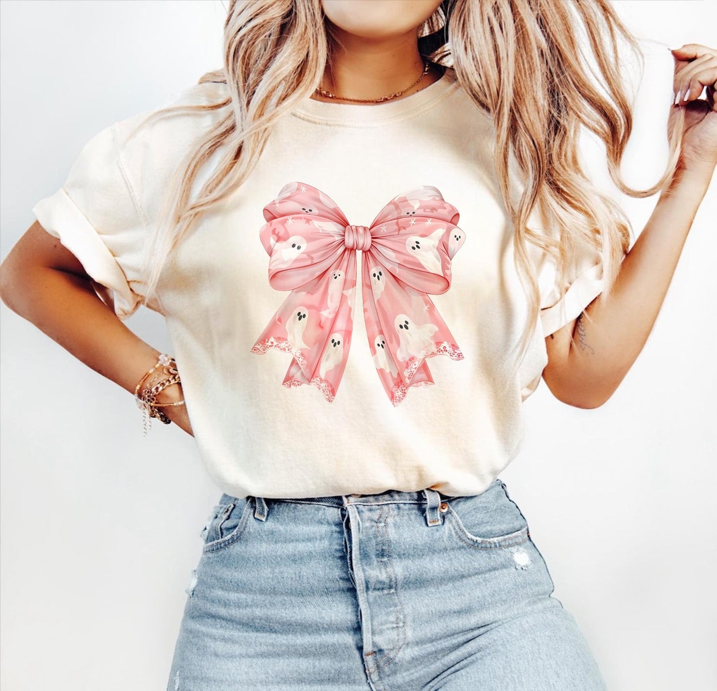 Woman wearing a personalized pink Halloween shirt with a pink bow and ghost design
