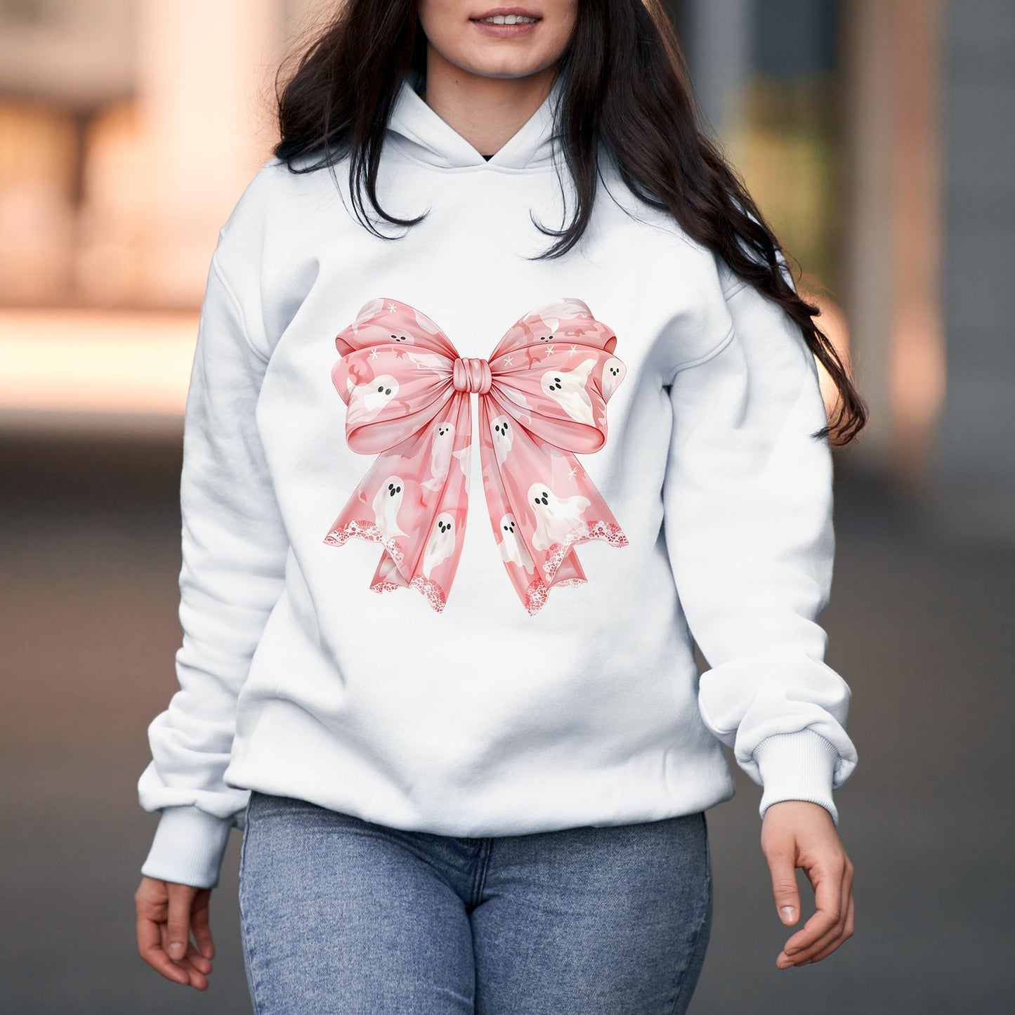 White hoodie featuring a personalized pink Halloween shirt design with a large pink bow and ghost patterns
