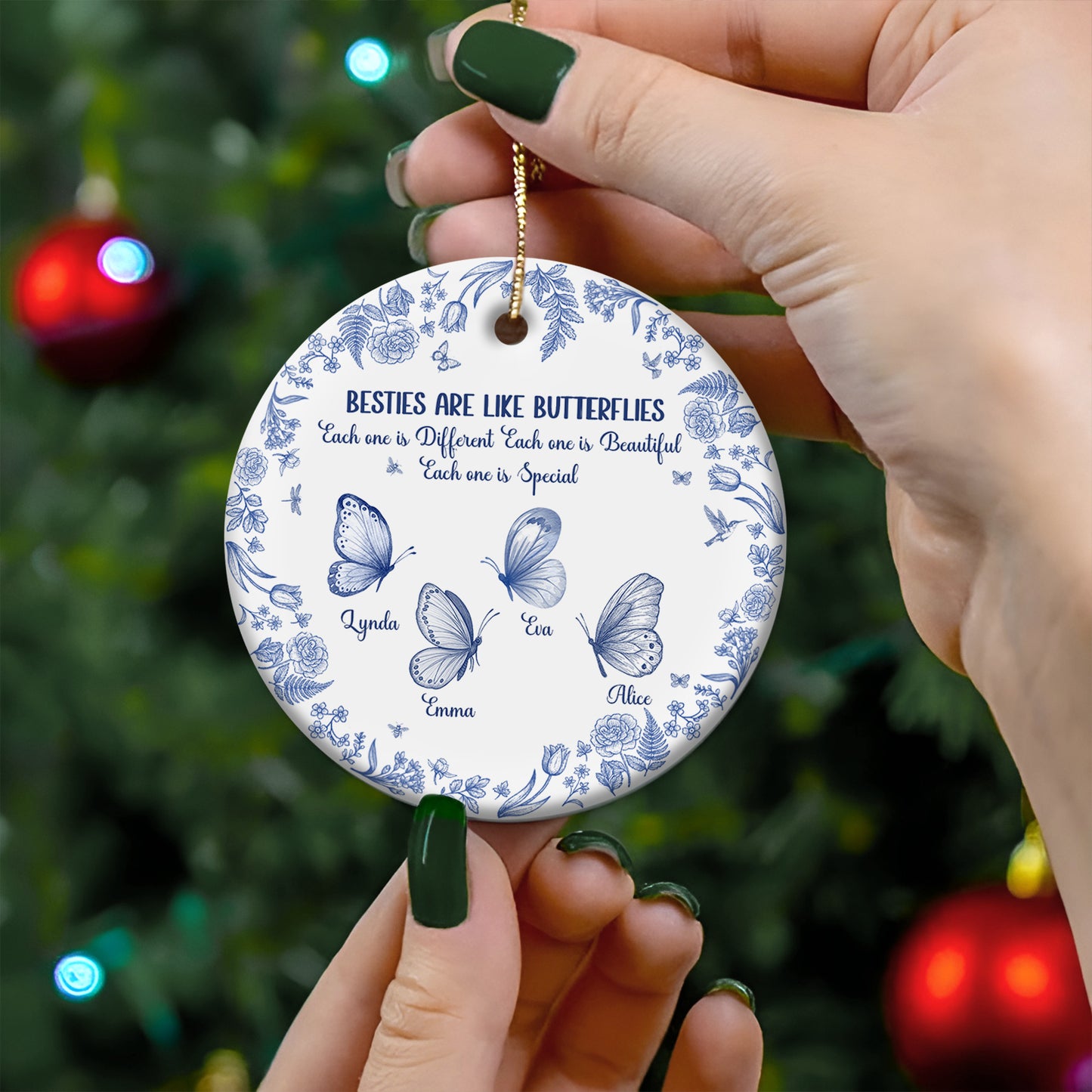 personalized sister ornament white ceramic with blue butterfly design and four names held by hands