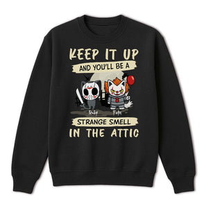 Black crewneck sweatshirt featuring two cartoon cats dressed as horror icons with text and personalized Halloween cat shirt