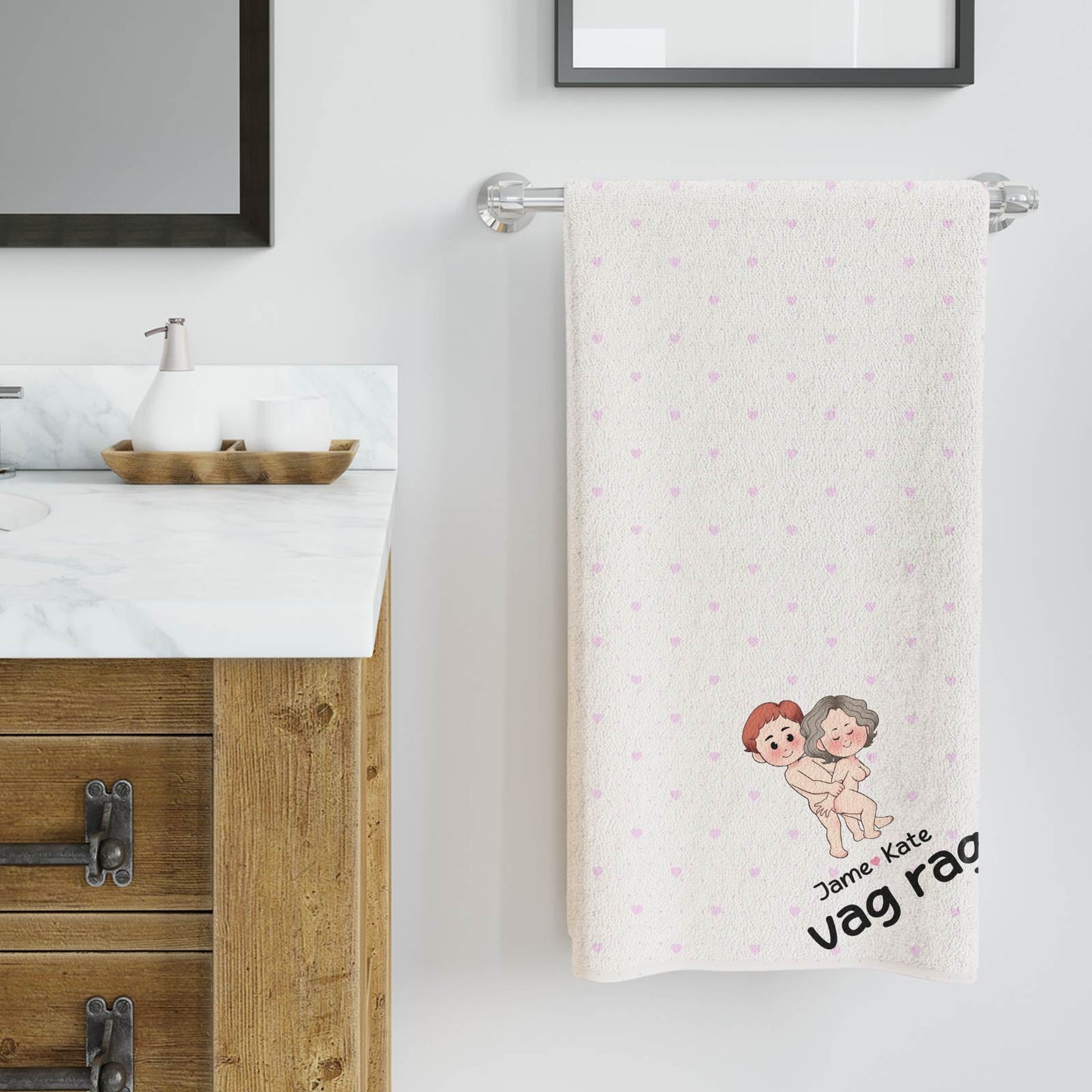 Personalized Beach Towel white with small pink hearts and custom couple illustration draped on bathroom towel bar
