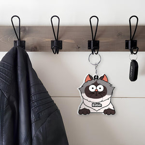 Unique shaking keychain for cat lovers featuring a cute cartoon cat design hanging on a coat hook