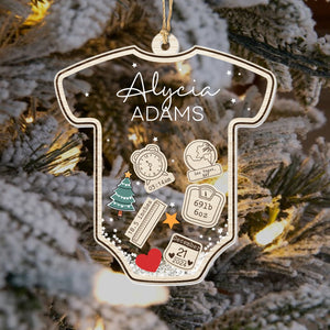 Personalized baby's first Christmas ornament shaped like a onesie with name and birth details