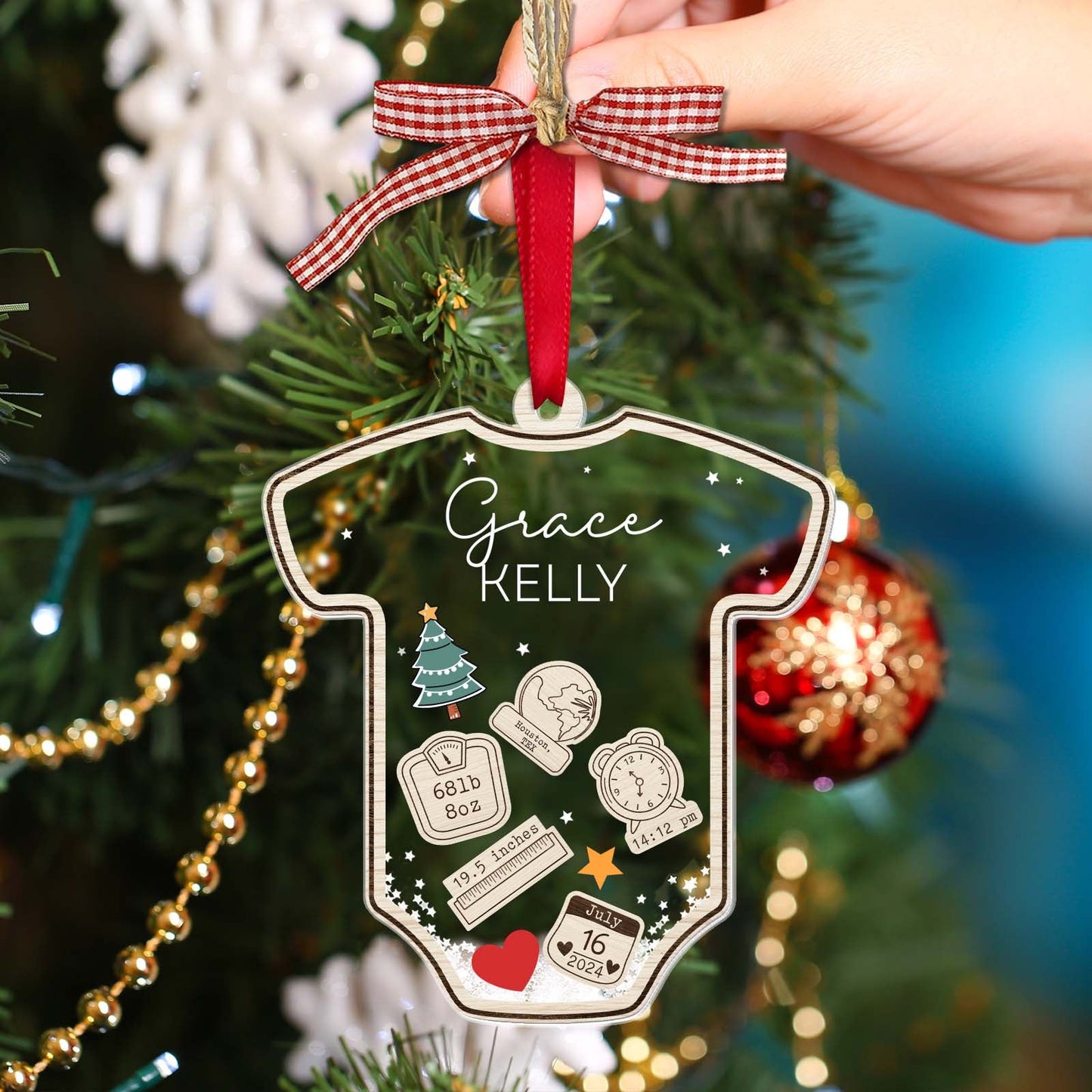 Personalized baby's first Christmas ornament shaped like a onesie with custom name and birth details