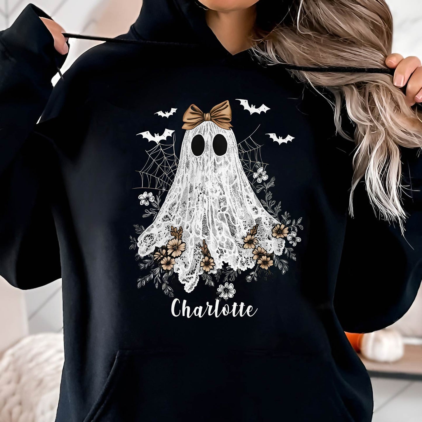 Black hoodie with personalized Halloween ghost shirt design featuring a lace ghost, bats, flowers, and the name Charlotte