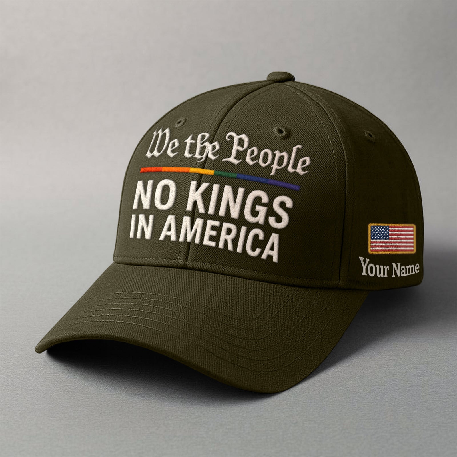We the People embroidered cap in olive green featuring customizable name and American flag patch
