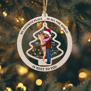 Personalized couple ornament featuring a kissing couple inside a Christmas tree frame with the phrase My favorite place in all the world is next to you