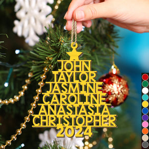 Yellow personalized Christmas tree ornament shaped like a tree with names and 2024 hanging on a Christmas tree