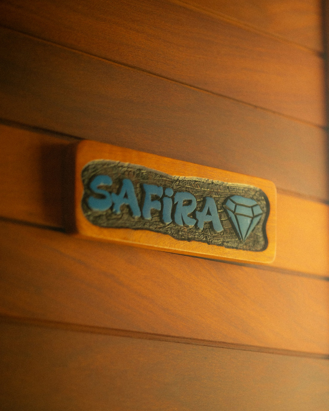 Wooden door with a nameplate that says safira.