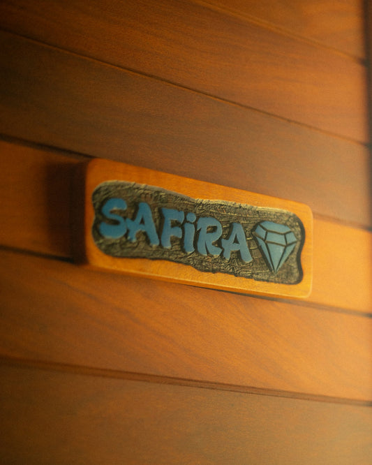Wooden door with a nameplate that says safira.