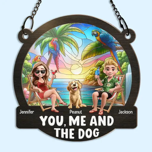 Personalized suncatcher ornament featuring a tropical beach scene with two people, a dog, and colorful parrots