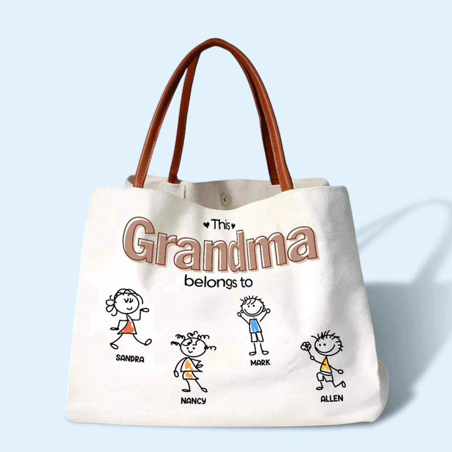 Personalized tote bags with custom family names and playful stick figure drawings on a white canvas bag
